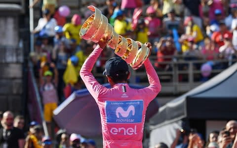 Ecuadorian rider Richard Carapaz of Movistar team celebrates with the trophy - Credit: Rex