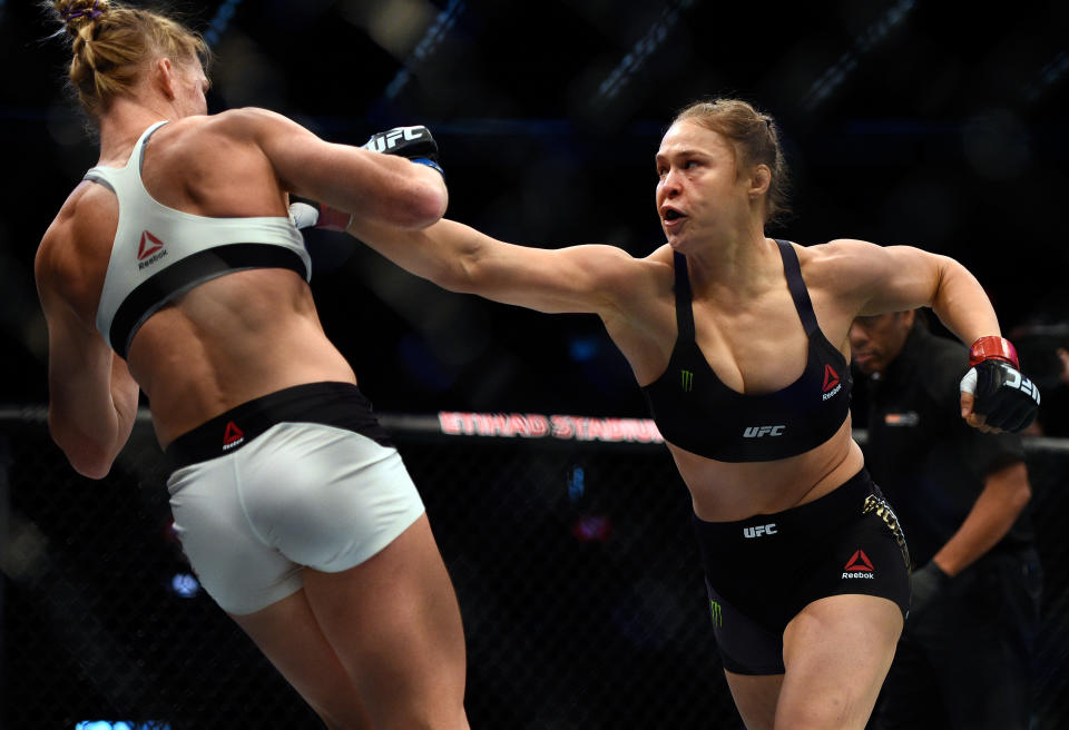 MELBOURNE, AUSTRALIA - NOVEMBER 15: (R-L) Ronda Rousey punches Holly Holm in their UFC women's bantamweight championship bout during the UFC 193 event at Etihad Stadium on November 15, 2015 in Melbourne, Australia. (Photo by Jeff Bottari/Zuffa LLC/Zuffa LLC via Getty Images)