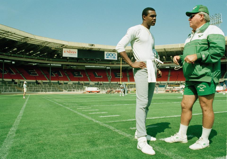 Randall Cunningham, quarterback for the Philadelphia Eagles talks with head coach Buddy Ryan during a light training session, Aug. 5, 1989, at London's Wembley Stadium where they will take on the Cleveland Browns for the 1989 American Bowl.