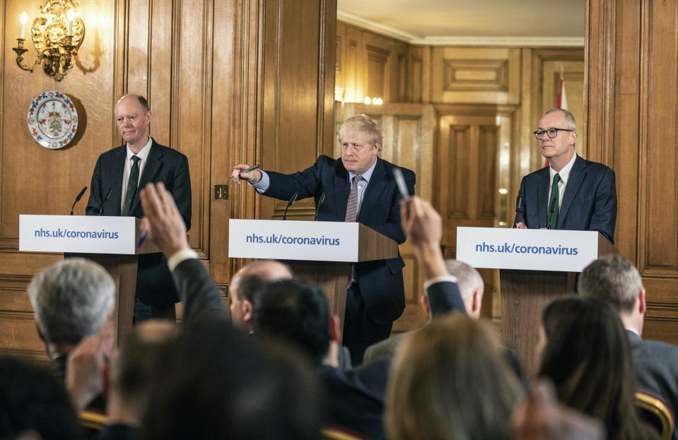 Prime Minister Boris Johnson gives a press conference with England's chief medical officer Chris Whitty, left, and Chief scientific officer Patrick Vallance, about the ongoing situation with the COVID-19 coronavirus pandemic at 10 Downing Street in London, Monday March 16, 2020. According to the World Health Organization, the vast majority of people recover from the new COVID-19 coronavirus in about two to six weeks depending on the severity of the illness. (Richard Pohle/Pool via AP)