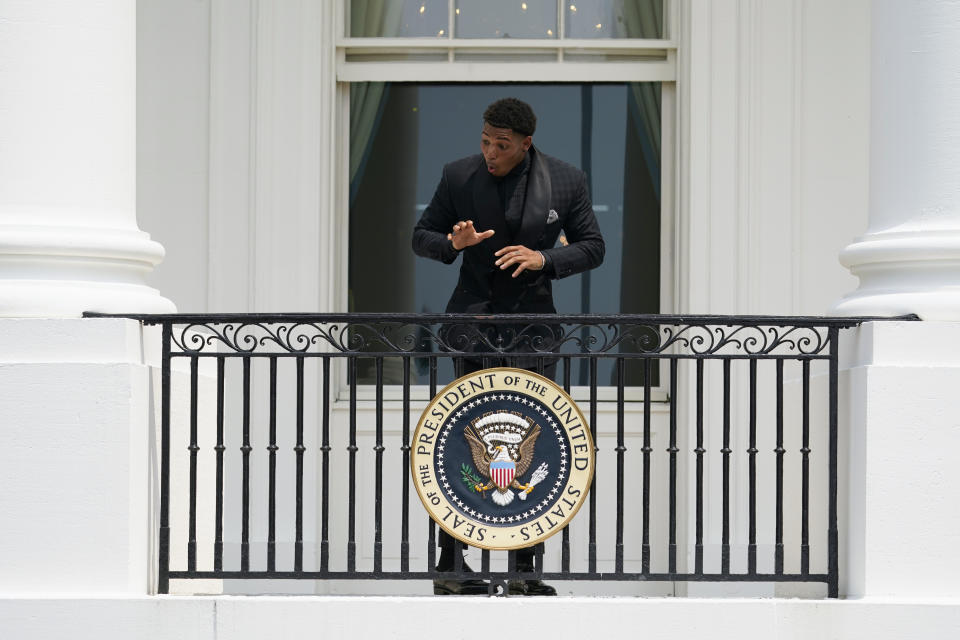 Tampa Bay Buccaneers cornerback Sean Murphy-Bunting reacts after being asked to get down from the balcony at the White House before a ceremony on the South Lawn of the White House, in Washington, Tuesday, July 20, 2021, where President Joe Biden will honor the Super Bowl Champion Tampa Bay Buccaneers for their Super Bowl LV victory. (AP Photo/Andrew Harnik)