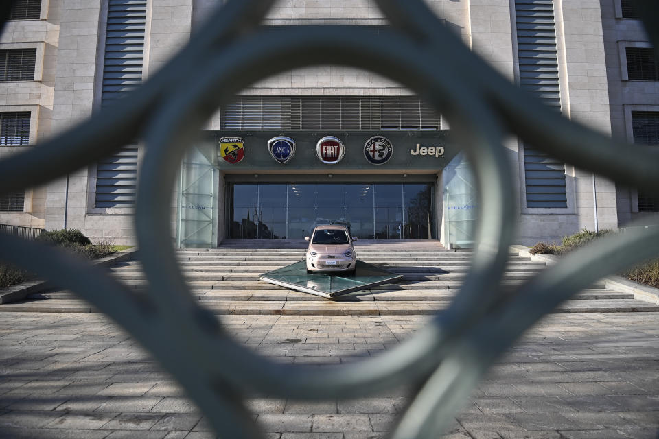 The new Stellantis logo was added on the side of the other logos of the group, on the day of the stock market debut, at the historic Mirafiori headquarters in Turin, Italy, Monday, Jan. 18, 2021. Stellantis, the car company combining PSA Peugeot and Fiat Chrysler, was launched Monday on the Milan and Paris stock exchanges, giving life to the fourth-largest car company in the world. (Marco Alpozzi/LaPresse via AP)