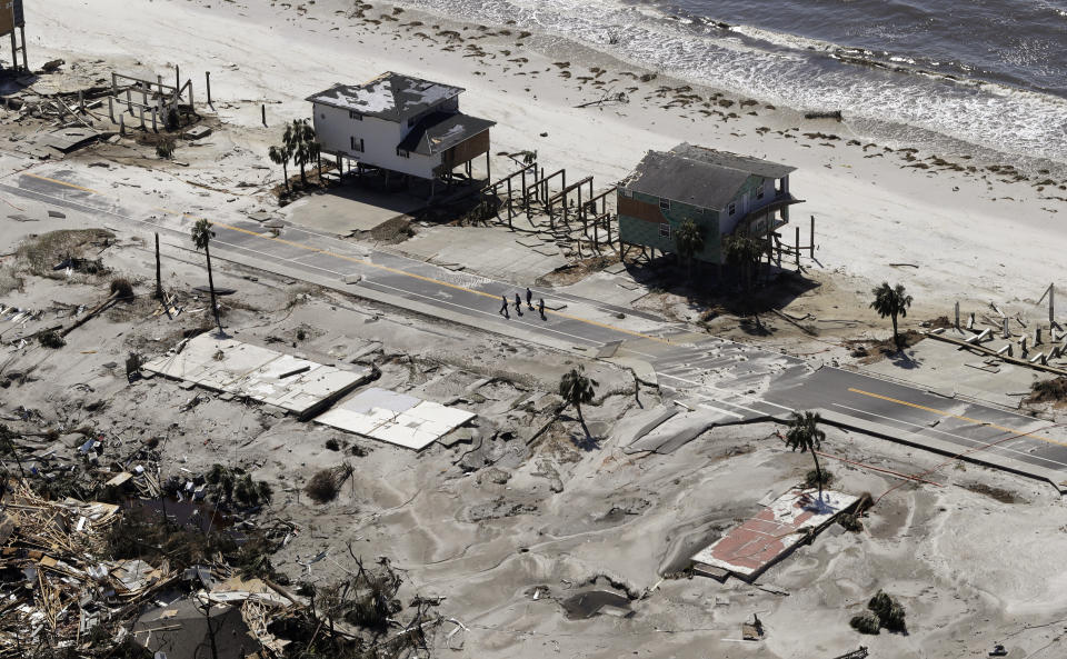 Homes are left swept off their foundations from the effects of Hurricane Michael, Thursday, Oct. 11, 2018, in Mexico Beach, Fla. Michael made landfall Wednesday as a Category 4 hurricane with 155 mph (250 kph) winds and a storm surge of 9 feet (2.7 meters). (AP Photo/Chris O'Meara)