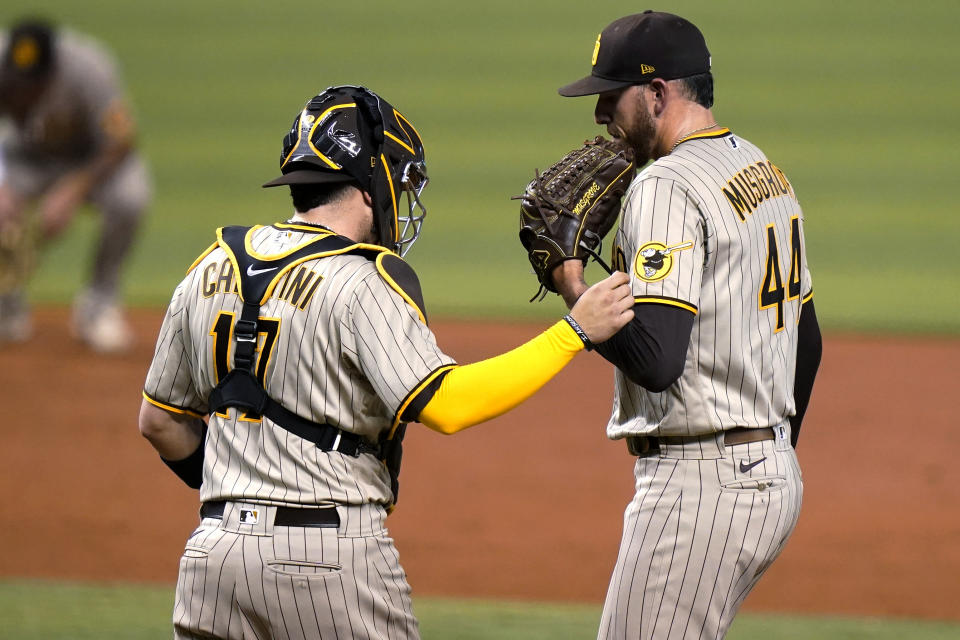 San Diego Padres catcher Victor Caratini (17) talks with starting pitcher Joe Musgrove (44) during the third inning of the team's baseball game against the Miami Marlins, Friday, July 23, 2021, in Miami. (AP Photo/Lynne Sladky)