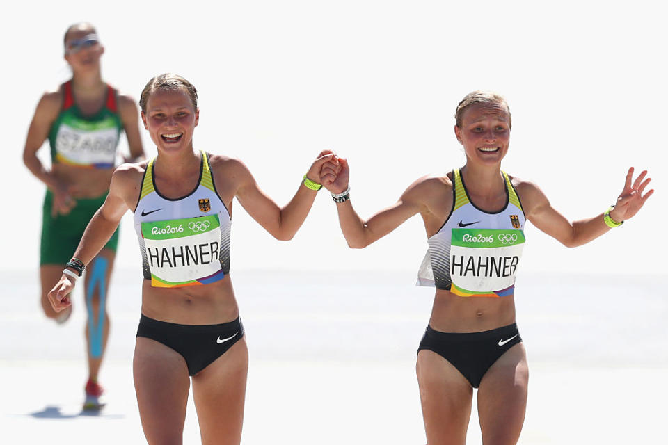 Twin sisters Lisa (left) and Anna Hahner cross the women's marathon finish line hand in hand. (Getty Images) 