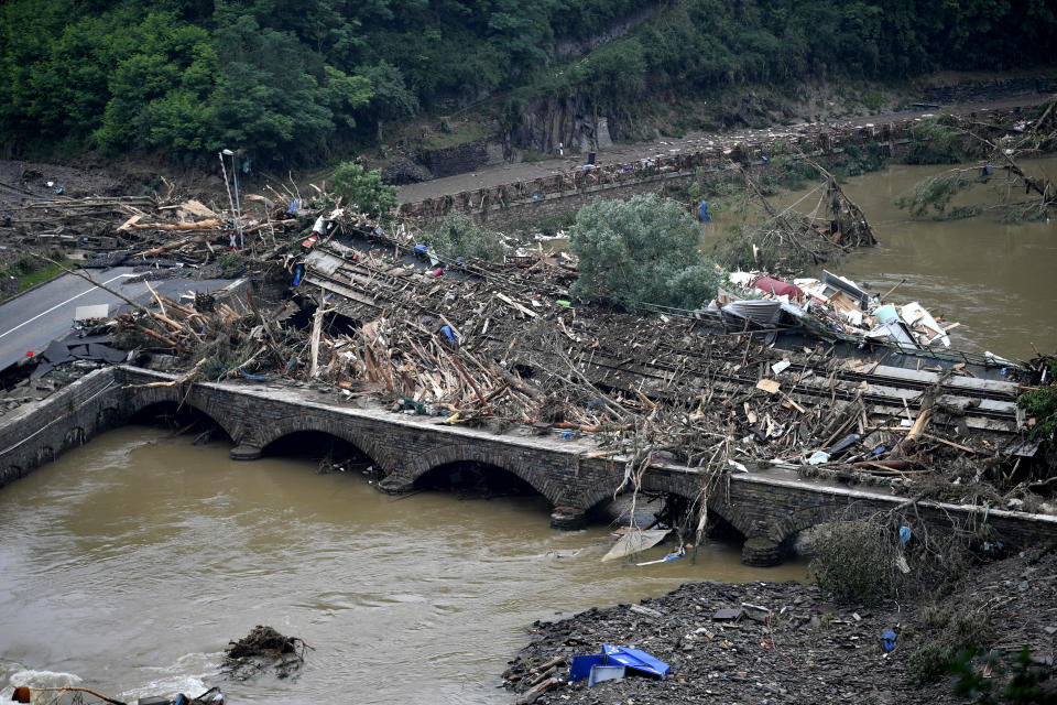 Two bridges at the river Ahr are blocked by rubble in Altenahr, western Germany, Saturday, July 17, 2021. Heavy rains caused mudslides and flooding in the western part of Germany. Multiple have died and are missing as severe flooding in Germany and Belgium turned streams and streets into raging, debris-filled torrents that swept away cars and toppled houses. (Lino Mirgeler/dpa via AP)