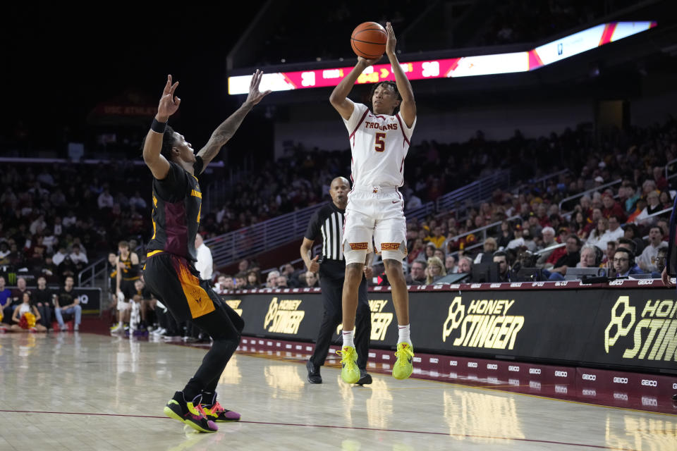 Southern California guard Boogie Ellis (5) shoots over Arizona State guard Desmond Cambridge Jr. during the second half of an NCAA college basketball game Saturday, March 4, 2023, in Los Angeles. (AP Photo/Marcio Jose Sanchez)