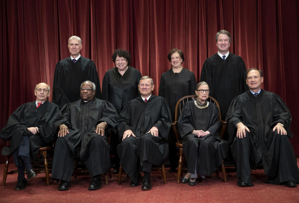 FILE - In this Nov. 30, 2018, file photo, the justices of the U.S. Supreme Court gather for a formal group portrait to include a new Associate Justice, top row, far right, at the Supreme Court Building in Washington. Seated from left: Associate Justice Stephen Breyer, Associate Justice Clarence Thomas, Chief Justice of the United States John G. Roberts, Associate Justice Ruth Bader Ginsburg and Associate Justice Samuel Alito Jr. Standing behind from left: Associate Justice Neil Gorsuch, Associate Justice Sonia Sotomayor, Associate Justice Elena Kagan and Associate Justice Brett M. Kavanaugh. (AP Photo/J. Scott Applewhite, File)