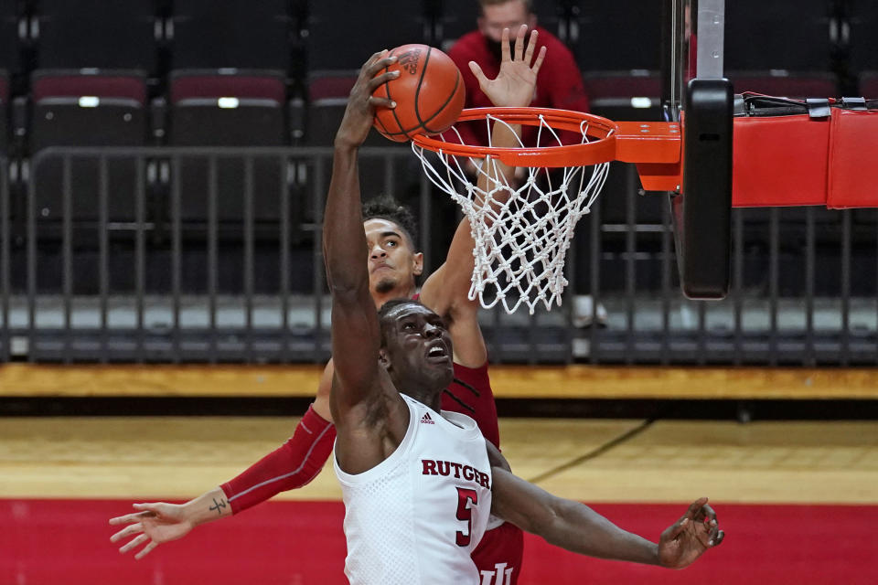 Rutgers center Cliff Omoruyi (5) misses a dunk with Indiana guard Khristian Lander defending during the second half of an NCAA college basketball game, Wednesday, Feb. 24, 2021, in Piscataway, N.J.(AP Photo/Kathy Willens)