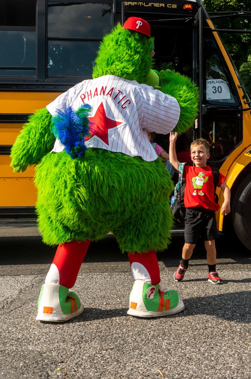 The Phillie Phanatic hi-fives Rowan Linder, a 5 year-old big-time baseball fan who is battling cancer, at his school bus stop before showing him his newly decorated Phillies-themed bedroom in Middletown on Thursday, Sept. 7, 2023.

[Daniella Heminghaus | Bucks County Courier Times]