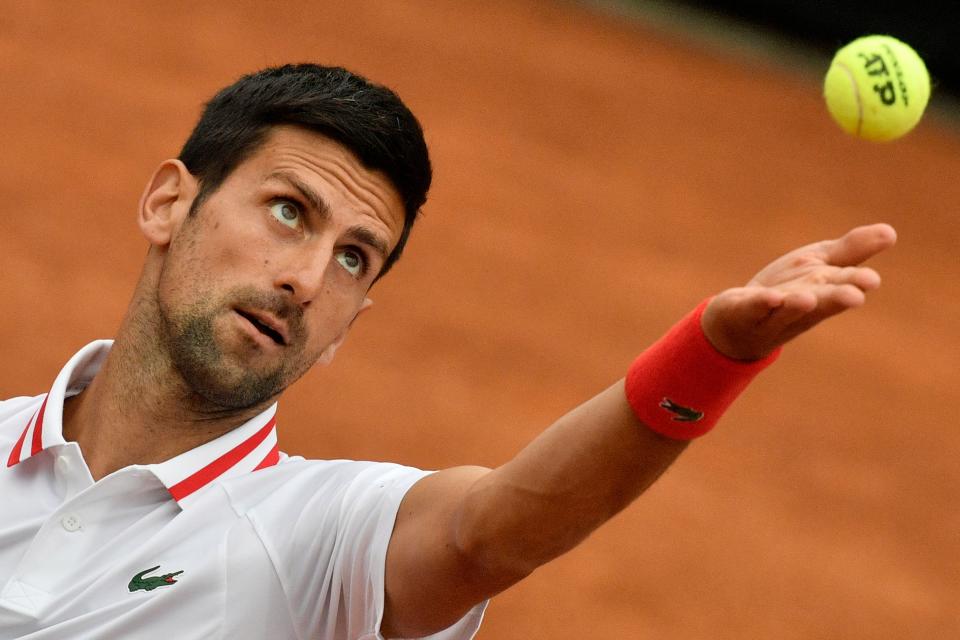 Serbia's Novak Djokovic serves to USA's Taylor Fritz during their first round match of the Men's Italian Open at Foro Italico on May 11, 2021 in Rome, Italy. (Photo by Filippo MONTEFORTE / AFP) (Photo by FILIPPO MONTEFORTE/AFP via Getty Images)