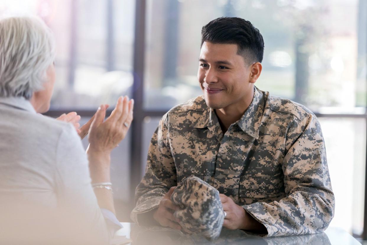 smiling soldier in uniform talks to interviewer