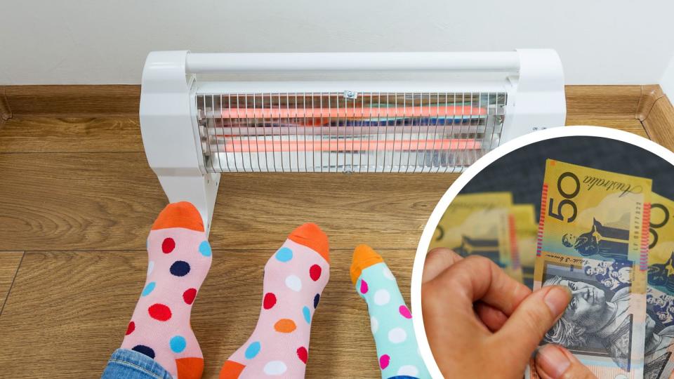 Person keeping feet warm by heater and money