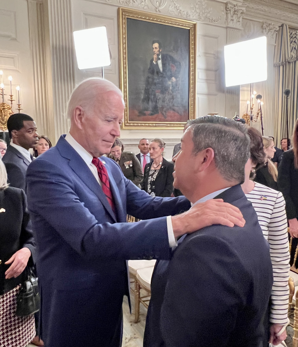 President Joe Biden speaks with U.S. Sen. Ben Ray Lujan at the signing of a bill extending federal reparations for those exposed to radiation from government projects, June 7, 2022 at the White House.