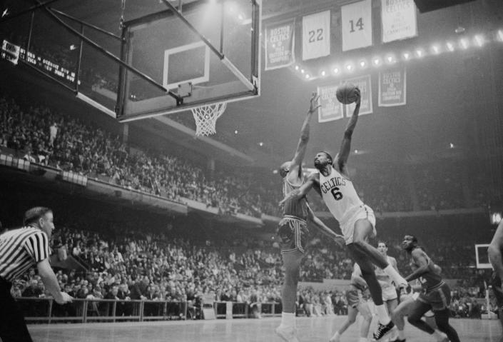 The Boston's Celtic's Bill Russell goes in high to score as St. Louis Hawk's Zelmo Beaty tries to block in 1963. (Bettmann Archive via Getty Images file)