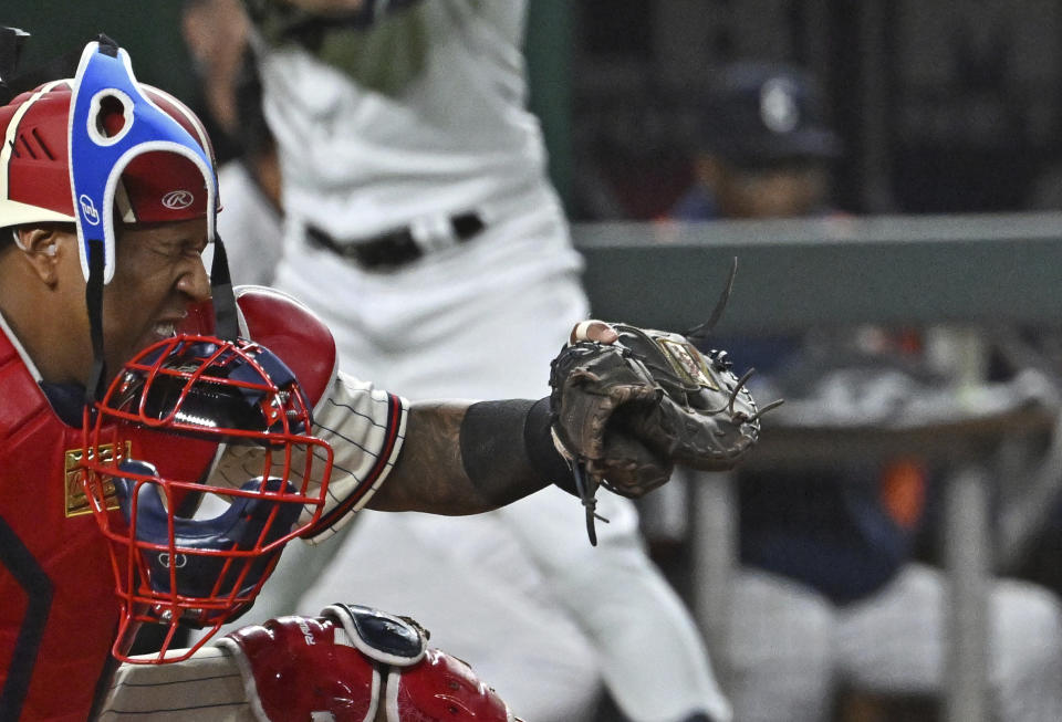 Kansas City Royals catcher Salvador Perez takes a foul ball off the mask during the fifth inning of a baseball game against the Houston Astros, Saturday, Sept. 16, 2023, in Kansas City, Mo. (AP Photo/Peter Aiken)