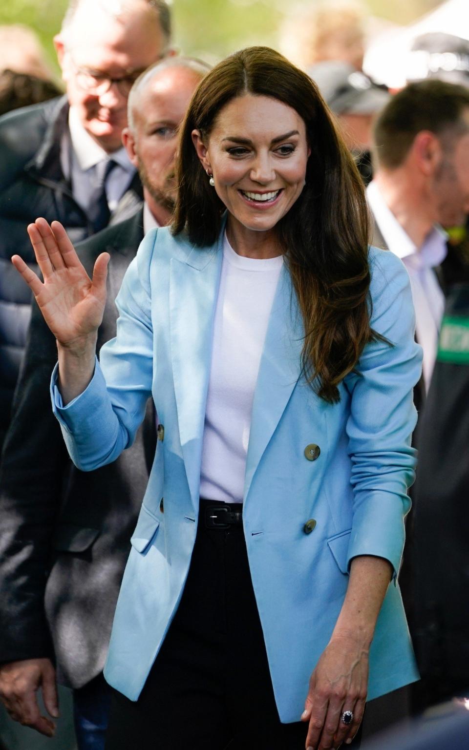 Catherine, Princess of Wales wears a Reiss blazer as she waves while walking with members of the public on the Long Walk near Windsor Castle on May 7, 2023