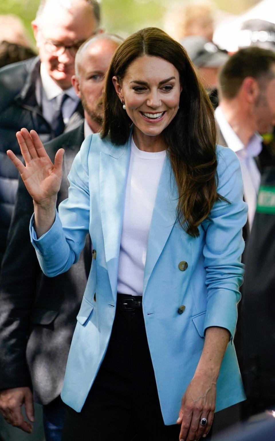 Catherine, Princess of Wales wears a jacket from Reiss as she waves during a public walk on the Long Walk near Windsor Castle on May 7, 2023