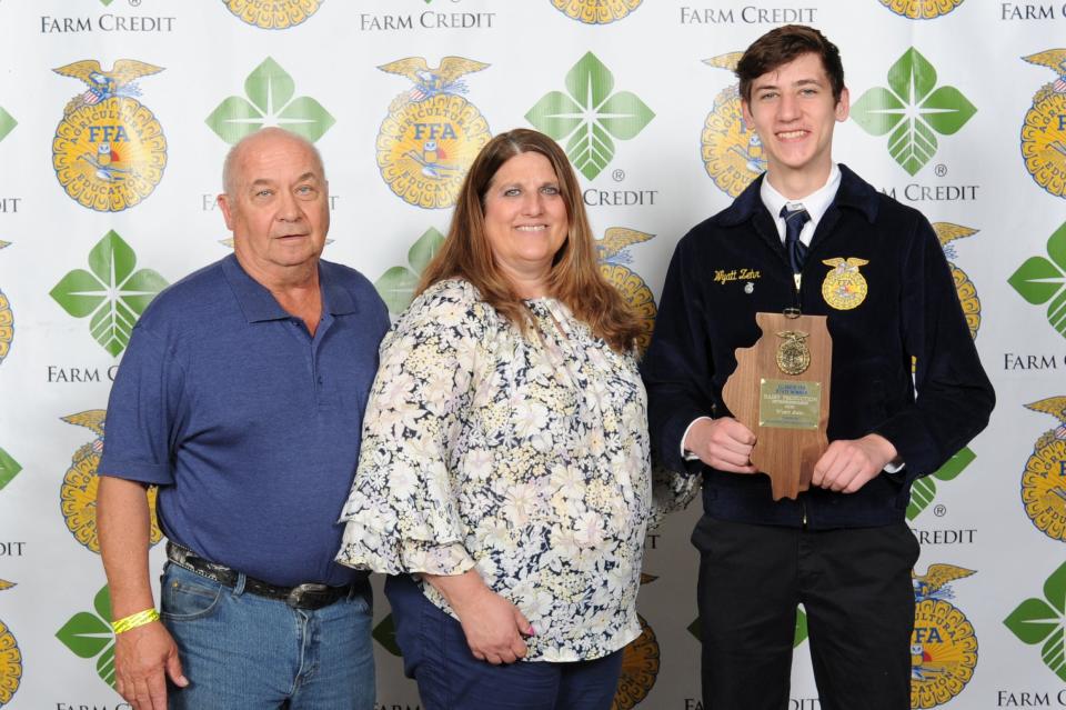 Wyatt Zehr, right, shown here with parents Gary and Tricia Zehr, was selected as the State FFA Proficiency winner in Dairy Production Entrepreneurship at the 94th annual Illinois State FFA Convention.