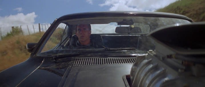 Mel Gibson as Max Rockatansky behind the wheel of his car in the original Mad Max