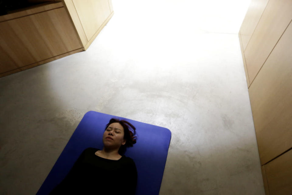 Zhang Kun, an employee at BaishanCloud, practices yoga before lunch at the office in Beijing on April 26, 2016. (Jason Lee/Reuters)