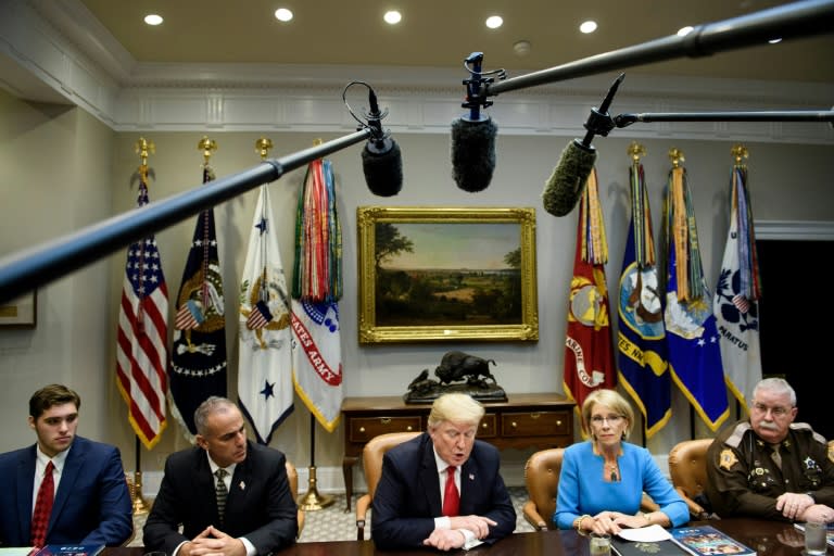 US President Donald Trump, speaking during a roundtable discussion about school safety at the White House, is seen next to Education Secretary Betsy DeVos who led a federal commission on the topic