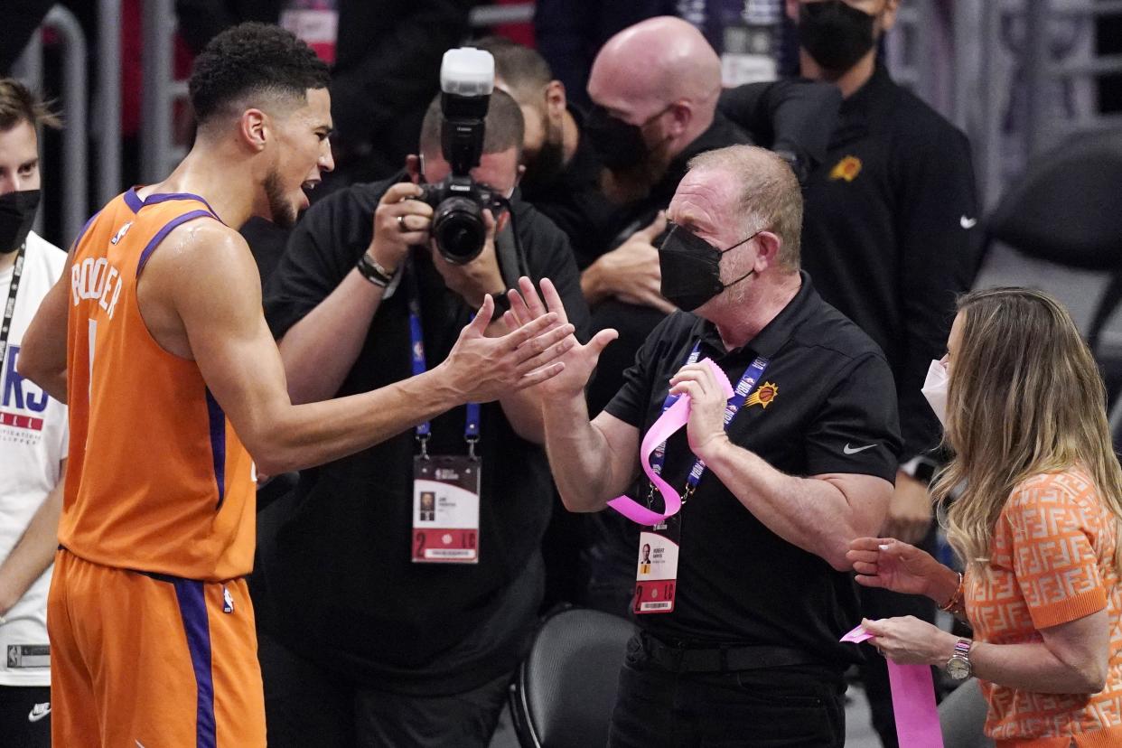 Phoenix Suns' Devin Booker (left), celebrates with Suns owner Robert Sarver on  June 30, 2021.