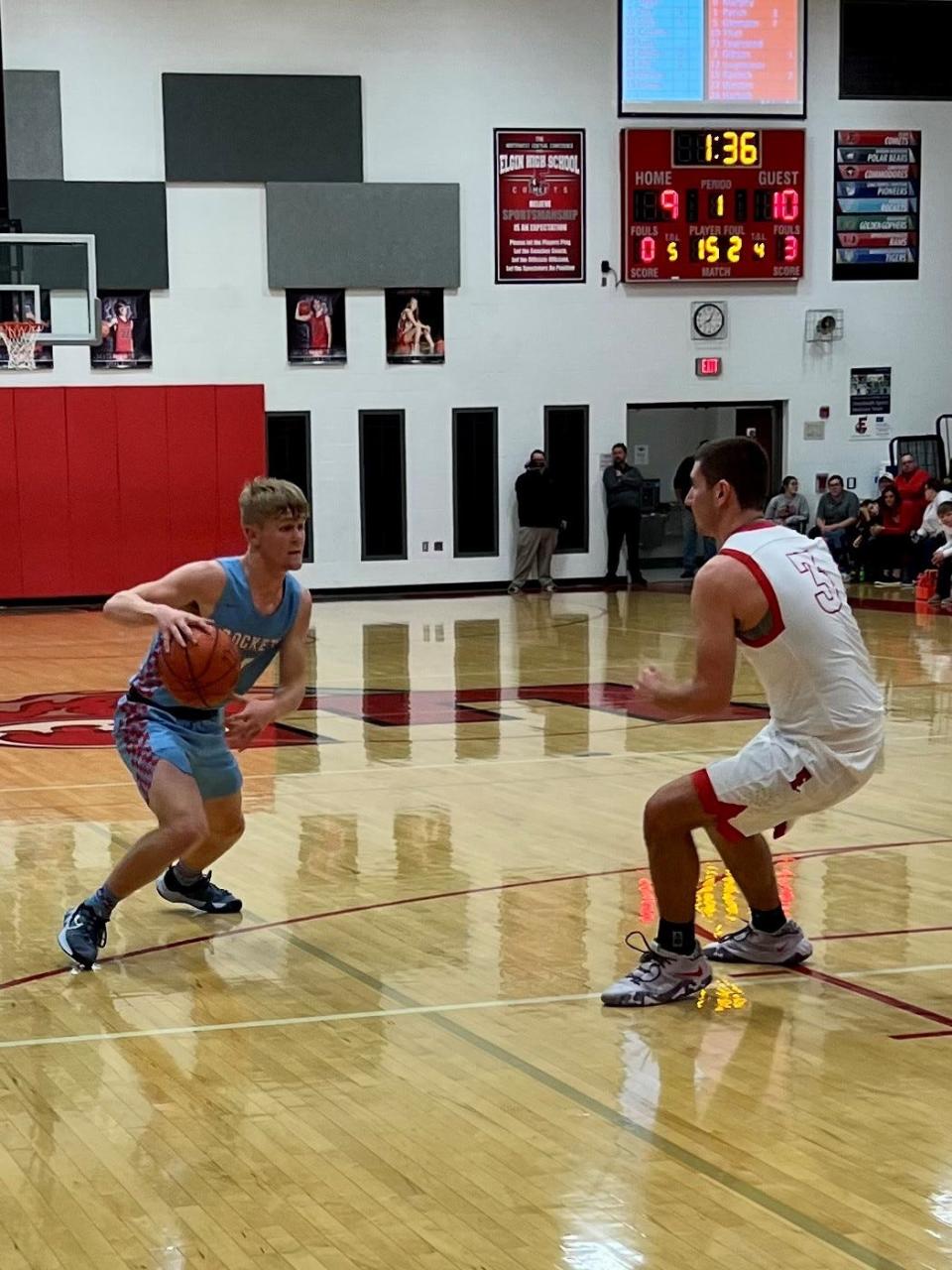 Ridgedale's Nathan Thiel drives to the basketball while being guarded by Elgin's Harrison Sager during Friday night's 56-53 overtime Comets win at home.