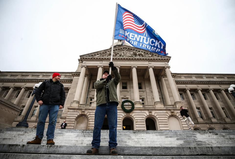 David Hanes waves a Trump flag as Jesiah St. Pierre looks on as the two supporters rallied for outgoing President Donald Trump on Wednesday morning, the day of the Electoral vote. Another protester with a megaphone called out Gov. Andy Beshear. Later in the day, Donald Trump's speech in Washington sparked hundreds of supporters to march on the U.S. Capitol and dozens breaking into the building, vandalizing and occupying the Senate chambers before order was restored Wednesday. Thursday, Jan. 7, 2021