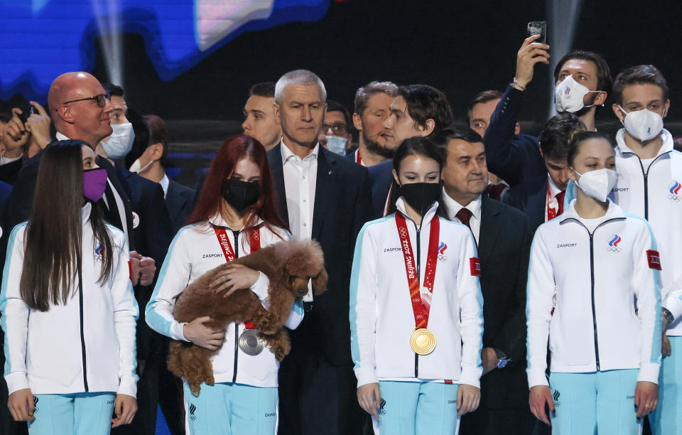 MOSCOW, RUSSIA - FEBRUARY 21, 2022: Russian figure skaters Kamila Valieva, Alexandra Trusova, Anna Sherbakova, Alexandra Boikova, Dmitry Kozlovsky (L-R front), Russia's Deputy Prime Minister Dmitry Chernyshenko, Russia's Sports Minister Oleg Matytsin and Russian Presidential Aide Igor Levitin (L-R background) attend a ceremony to honor Russian athletes who competed as Team ROC at the Beijing 2022 Olympics, at VTB Arena. Team ROC won 32 medals at the Winter Olympic Games and ranks ninth in the medal standings. Alexander Shcherbak/TASS (Photo by Alexander Shcherbak\TASS via Getty Images)