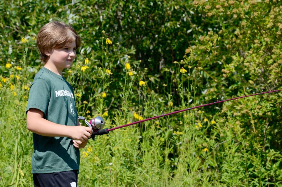Kyle Coatta, 8, of Levering works on his casting technique during a fishing game on Thursday, Aug. 3, 2023 at an open house at the Oden State Fish Hatchery.