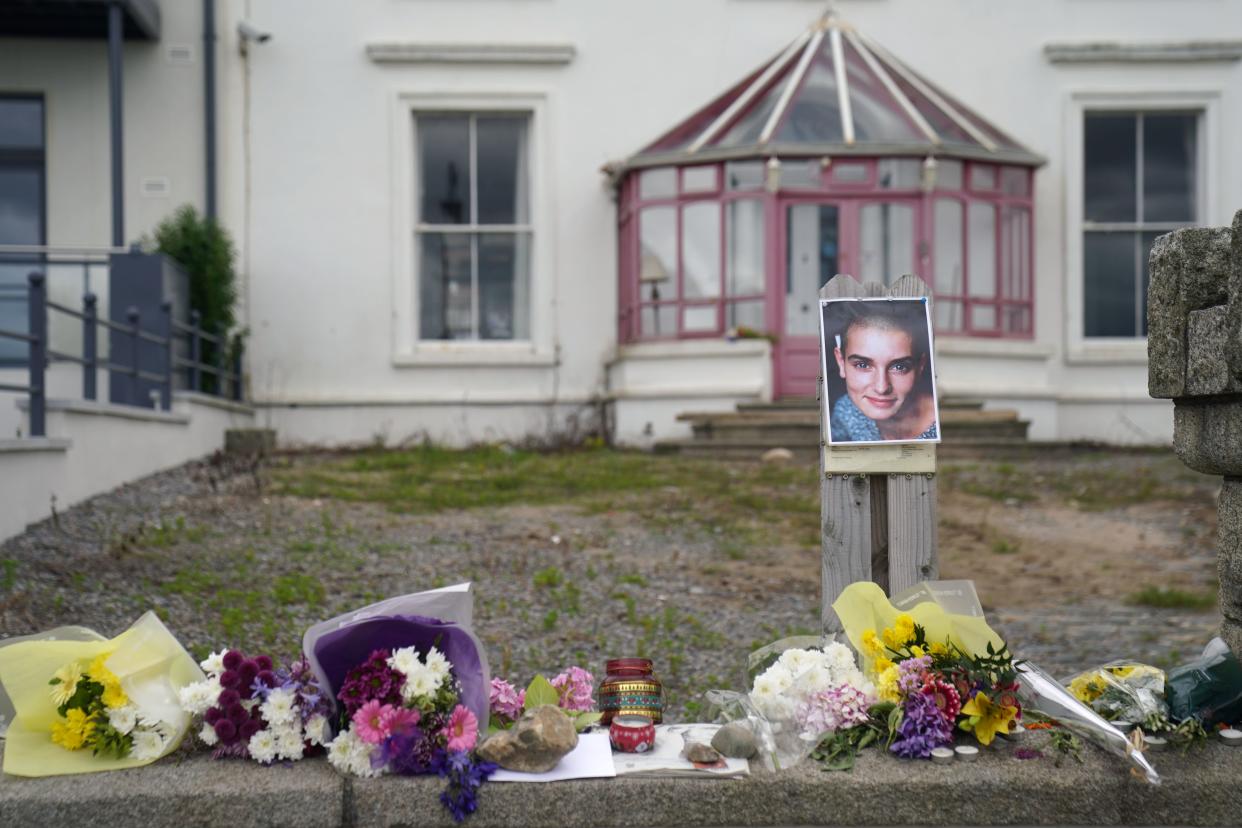 Floral tributes laid outside Sinead O’Connor’s former home in Bray (Brian Lawless/PA) (PA Wire)