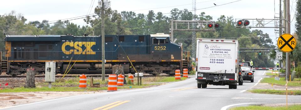 A CSX train crosses an intersection in Ocala.