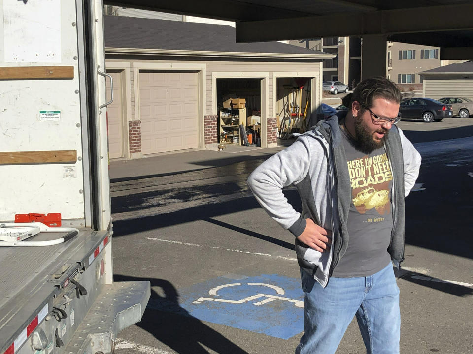 George Jankowski, a furloughed U.S. Department of Agriculture worker, helps a friend move out of an apartment in Cheyenne, Wyo., Monday, Jan. 14, 2019. Jankowski was paid $30 for his help. Many federal workers are doing odd jobs or driving for ride-hailing apps to help make ends meet during the partial federal government shutdown. (AP Photo/Mead Gruver)