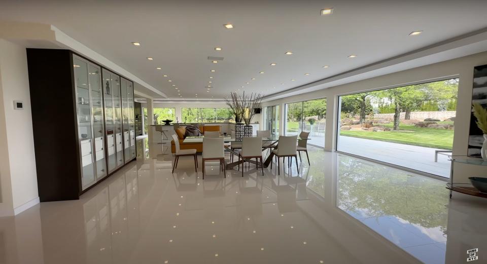 A white, modern dining room.