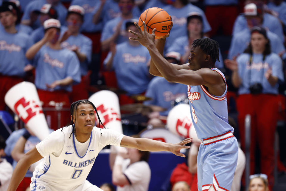 Dayton guard Enoch Cheeks, right, passes the ball next to Saint Louis guard Kellen Thames during the first half of an NCAA college basketball game in Dayton, Ohio, Tuesday, Jan. 16, 2024. (AP Photo/Paul Vernon)