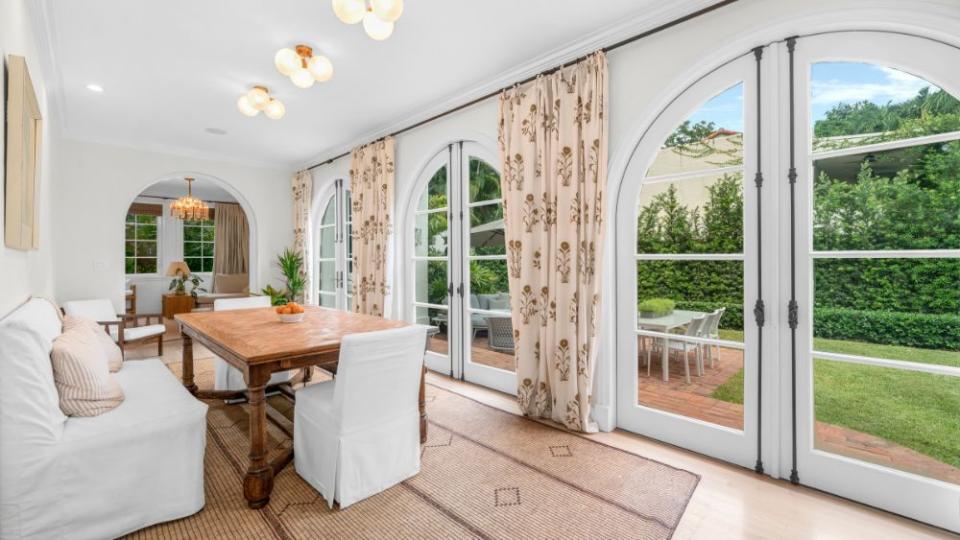 A formal dining room opens up to the outdoor patio. - Credit: 1oak Studios