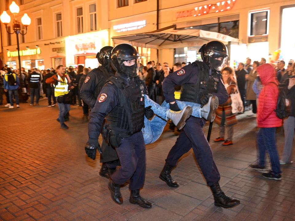 Police officers detain a person in Moscow on September 21, 2022, following calls to protest against partial mobilisation announced by President Vladimir Putin.