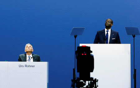 Chairman Urs Rohner and CEO Tidjane Thiam of Swiss bank Credit Suisse look up as activists of environmental group Greenpeace unveil a banner to protest against the financing of the Dakota-Access oil pipeline during the bank's annual shareholder meeting in Zurich, Switzerland April 28, 2017. REUTERS/Arnd Wiegmann