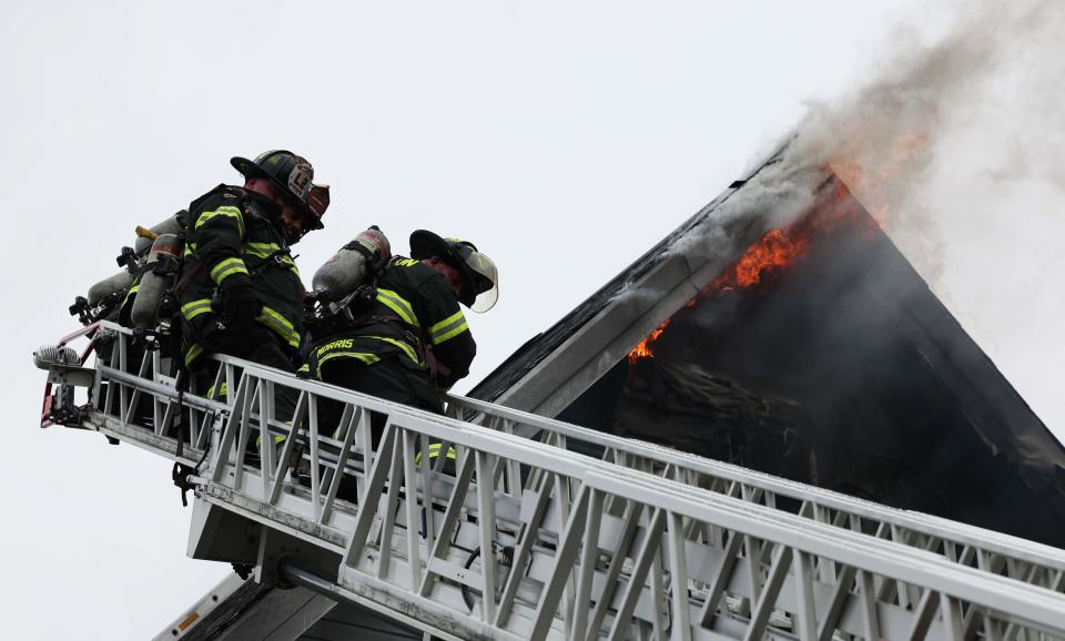 Brockton firefighters battle a two-alarm house fire at 9-11 Waverly St. on Monday, Dec. 11, 2023.