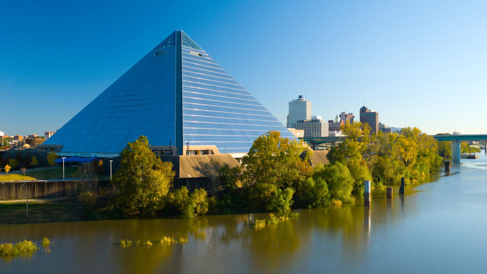 "The Pyramid Arena landmark building in Memphis, with the Memphis Downtown skyline in the background and Wolf River in the foreground.