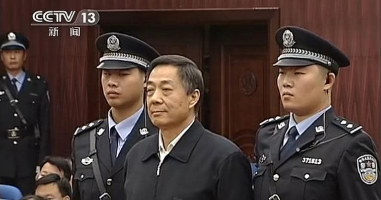 This screen grab taken from CCTV footage released on October 25, 2013 shows fallen politician Bo Xilai (front C) standing in the court room of Shandong High Court in Jinan, east China's Shandong province