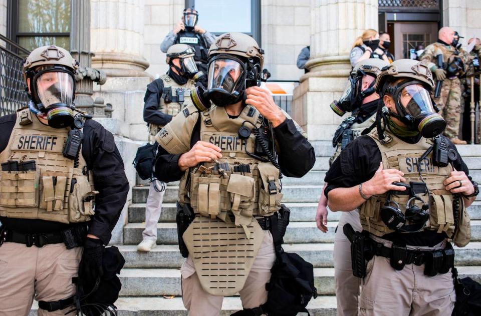 Alamance County sheriff’s deputies in riot gear prepare to arrest demonstrators after declaring an unlawful assembly during the march to the polls rally on Oct. 31, 2020.