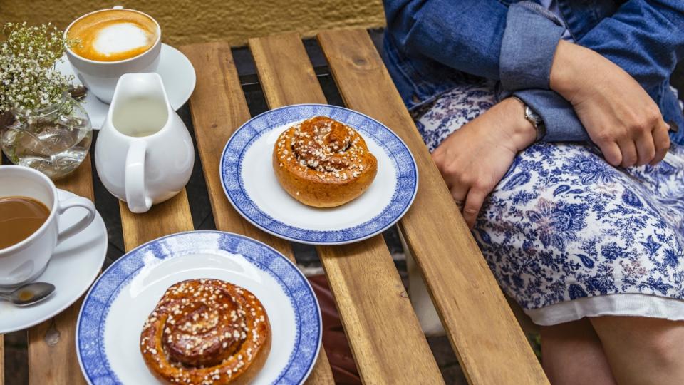 A woman with coffee and pastries