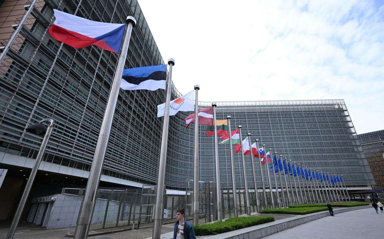 Flags flying at the Berlaymont building, headquarters of the European Commission in Brussels, Belgium