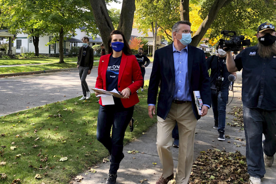 Michigan Gov. Gretchen Whitmer campaigns with Dan O'Neil, a Democratic candidate for the Michigan House in Traverse City, Mich., Friday, Oct. 9, 2020. Whitmer visited the area the day after police announced a foiled plot to kidnap the governor. (AP Photo/John Flesher)