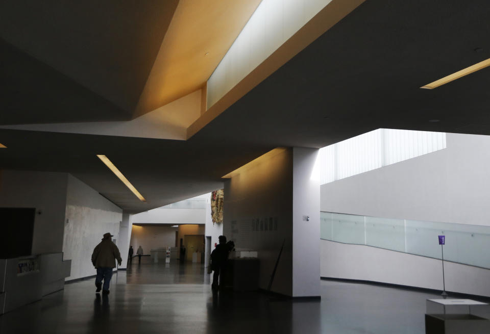 This Feb. 12, 2014 photo shows a visitor walking through the galleries of the Nelson-Atkins Museum of Art in Kansas City, Mo. The museum is home to high-caliber collections that include great works ranging from the photography of Edward Steichen to ancient Chinese scrollwork. (AP Photo/Orlin Wagner)