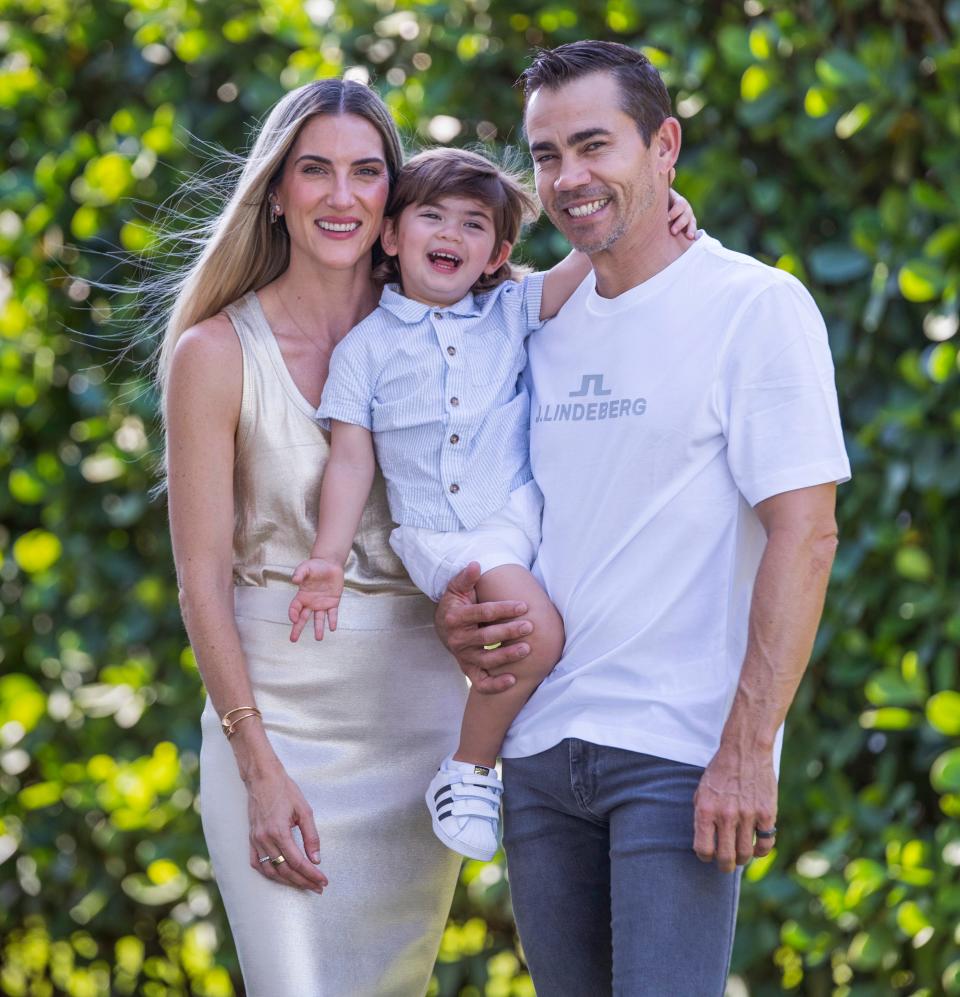 Maria and Camilo Villegas with their son Mateo, 2, at their home in Jupiter, Florida. Their 22 -month-old daughter Mia died from brain cancer in 2021. In her honor, they created Mia's Miracles, aimed at providing support to children and families facing challenging circumstances.