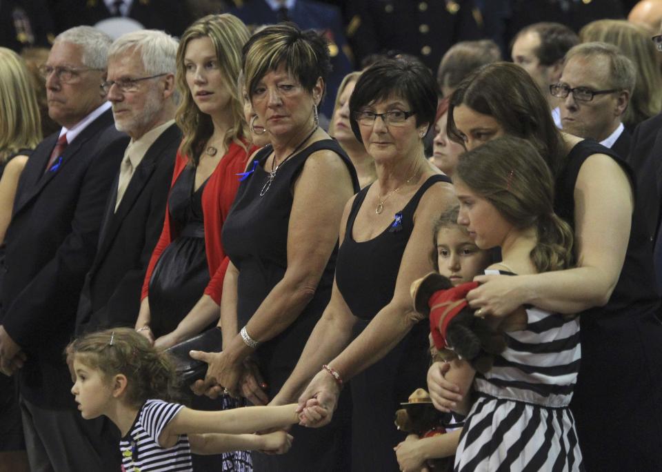 The family of Royal Canadian Mounted Police officer Douglas James Larche, one of three officers who were killed last week, attends a regimental funeral Moncton