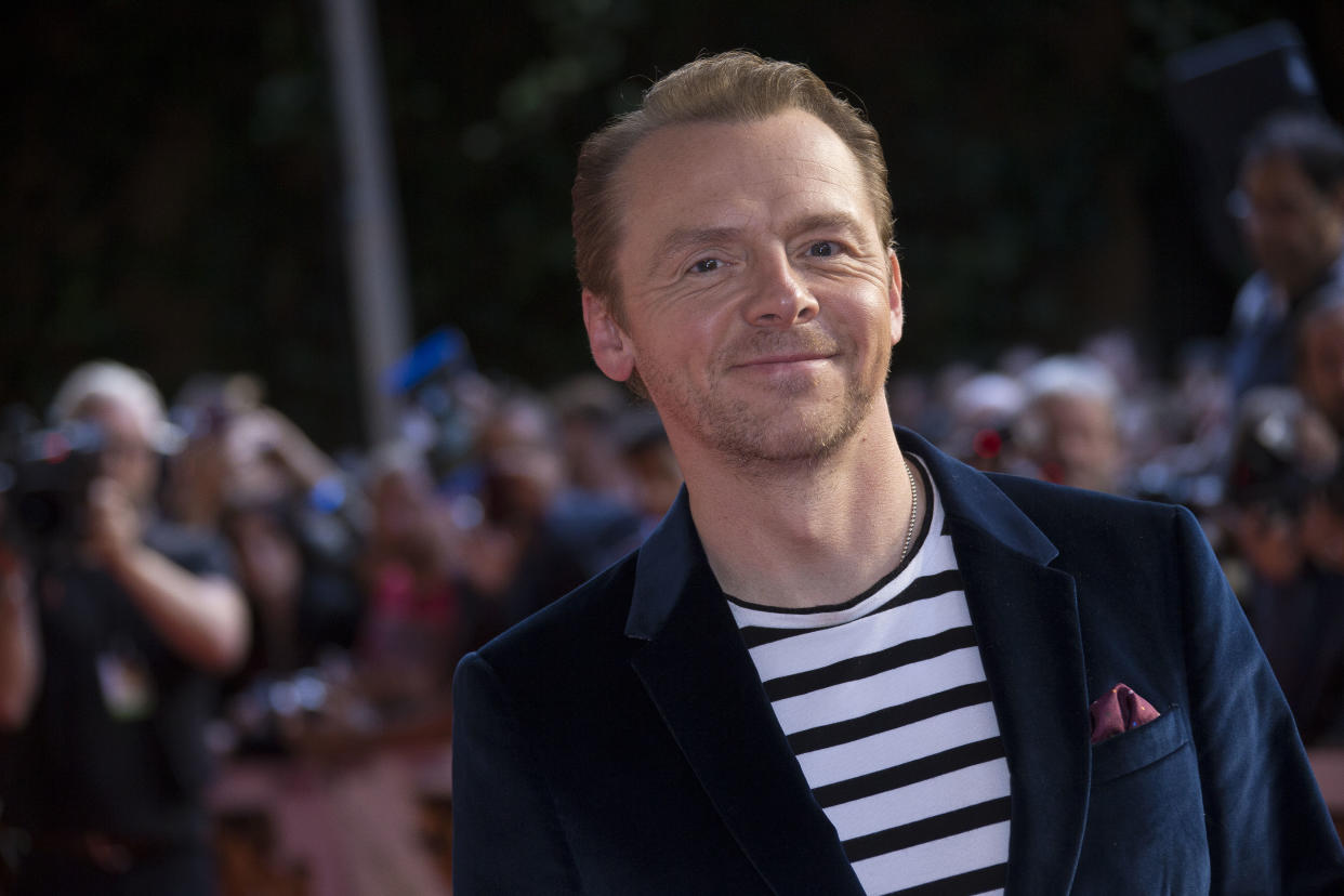 Actor Simon Pegg poses for photographers as he arrives for the UK premiere of Mission: Impossible- Rogue Nation, at the BFI IMax in central London, Saturday, July 25, 2015, which will be screened simultaneously in 14 screens across the UK. (Photo by Joel Ryan/Invision/AP)